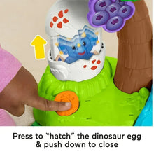 Dinosaur egg press feature with blue hatchling inside a white egg shell