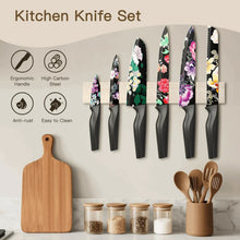 Six kitchen knives with floral blades and black handles, standing together