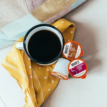 Coffee pods variety pack cups with dark coffee in mug and small pod sleeves