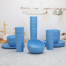 Blue plastic etched checkered dinnerware set with cups, bowls, and plates on display