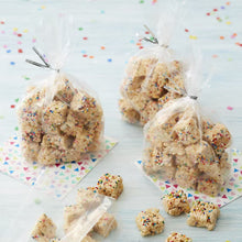 Clear treat bags with bow-tied tops, filled with sprinkled cookies