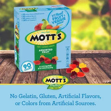 Mott's assorted fruit flavored snack box on wooden surface with loose gummies