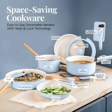 Pastel blue ceramic cookware set with detachable handles, lids, and serving spoon