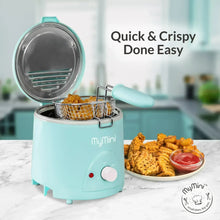 Aqua electric deep fryer with open lid, frying basket, and fried chicken with dipping sauce.