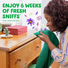 Woman wiping clothes with detergent; text reads "ENJOY 6 WEEKS OF FRESH"