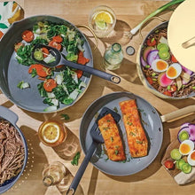 Buttercream cookware on table with covered pot and frying pan