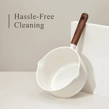 White ceramic nonstick saucepan with wooden-style handle and wide scoop rim