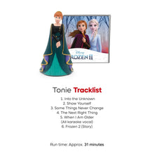 Elsa princess audio figurine with teal dress and dark cape, next to Frozen II artwork