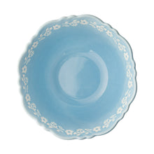Light blue embossed stoneware bowl interior with floral pattern and rim.