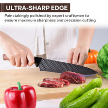 Hand holding a kitchen knife with textured black blade and brown wood-grain handle