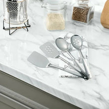 Stainless steel utensil set with spatula and spoon heads, on countertop