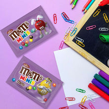 Purple M&M's Minis candy packets with colorful paper clips and markers