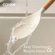 Silicone ladle pouring white batter, with light wood handle