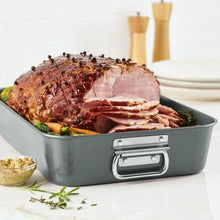 Gray nonstick roasting pan with removable flat rack, filled with carved roast