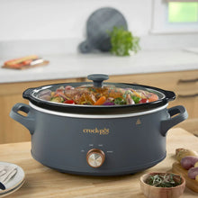Gray Crock-Pot manual slow cooker with glass lid and bronze control knob, food inside