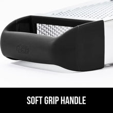 Black soft-grip handle of a stainless steel box grater