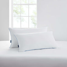 White king bed pillow set with blue piping on a white bed