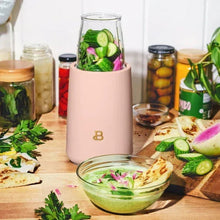 Rose personal blender base with clear jar of chopped vegetables and herbs, serving bowl nearby