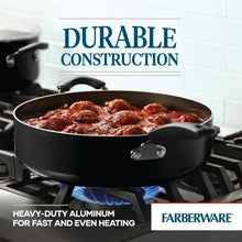 Black nonstick jumbo cooker on stovetop with two loop handles
