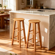 Two natural wood backless counter stools with round seats and ladder-style frames