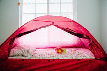 Twin bed tent interior with pink walls and open doorway, showing bed and light fabric liner