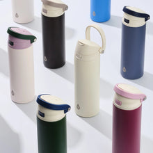 Assorted stainless steel 2-in-1 water bottles with push lids in mixed colors