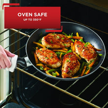 Nonstick fry pan in oven with golden chicken and vegetables inside