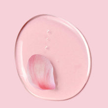 Pink shampoo gel swatch inside clear circular dish with rose-petal swirl