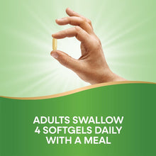 Hand holding a coconut oil softgel capsule