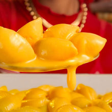 Cheesy macaroni with orange cheese sauce, shell pasta close-up