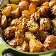 Garlic-herb roasted potato pieces in a bowl