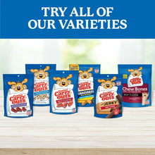 Assorted dog treat variety bags lineup on a blue background