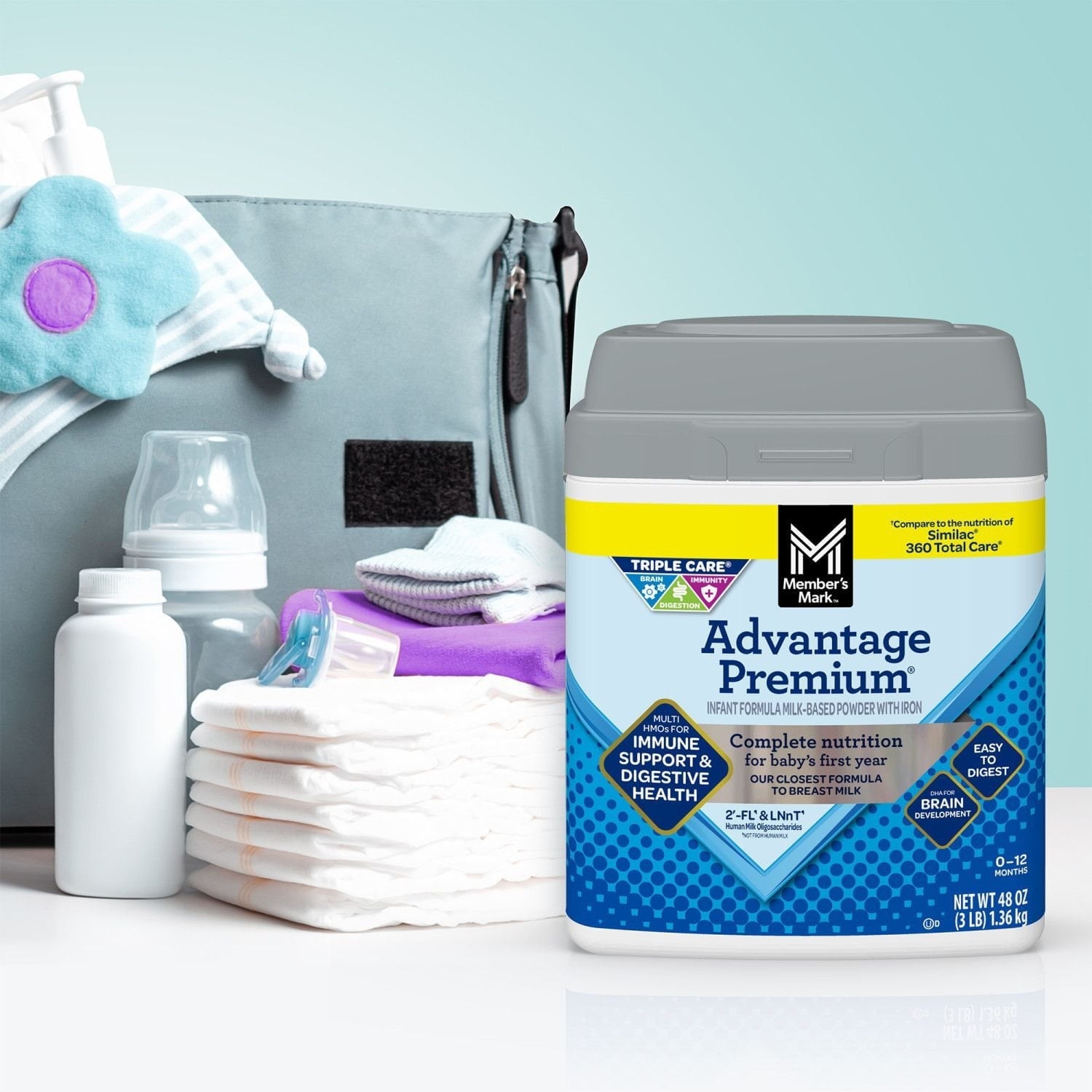 Advantage Premium infant formula canister with baby bottles and diapers in scene