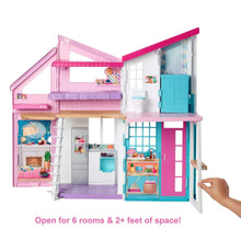 Open dollhouse playset with kitchen, bathroom, and living room rooms and furniture