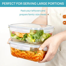 Two-stack clear glass food storage containers with snap lids held in hand