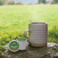Nantucket Blend K-Cup pod and gray mug with coffee on rock