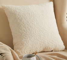 Ivory square boucle decorative pillow with textured woven surface