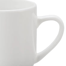 Glazed white stoneware mug close-up with C-shaped handle