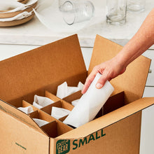 Glass packing kit small box with foam-padded glass placed between cardboard cells