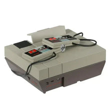 NES console ornament with controller buttons on top and open cartridge window
