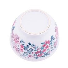 Pink and blue floral melamine mixing bowl with cream-trimmed rim, white exterior