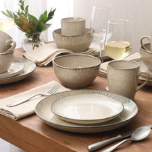 Cream reactive glaze stoneware set with bowls and plates, plus mugs and cups