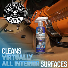 Total interior cleaner spray bottle beside car seats for interior surface cleaning