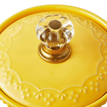 Yellow ceramic garlic keeper lid knob and embossed base details.