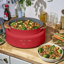 Tomato red multi-cooker with filled pot on the counter
