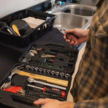 Tool set case with sockets and wrenches, plus screwdriver bits; hand holds a tool