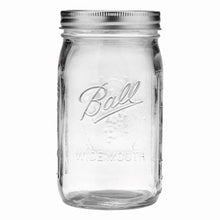 Clear wide-mouth glass mason jar with metal screw-top lid ring, empty