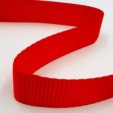 Coiled red webbing strap for a cam buckle tie-down