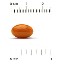 Orange CoQ10 softgel next to centimeter ruler for size