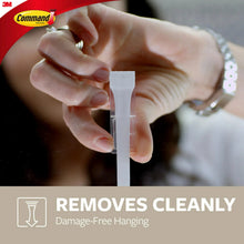 Hand applying adhesive strip to hook backing, double wall hook design